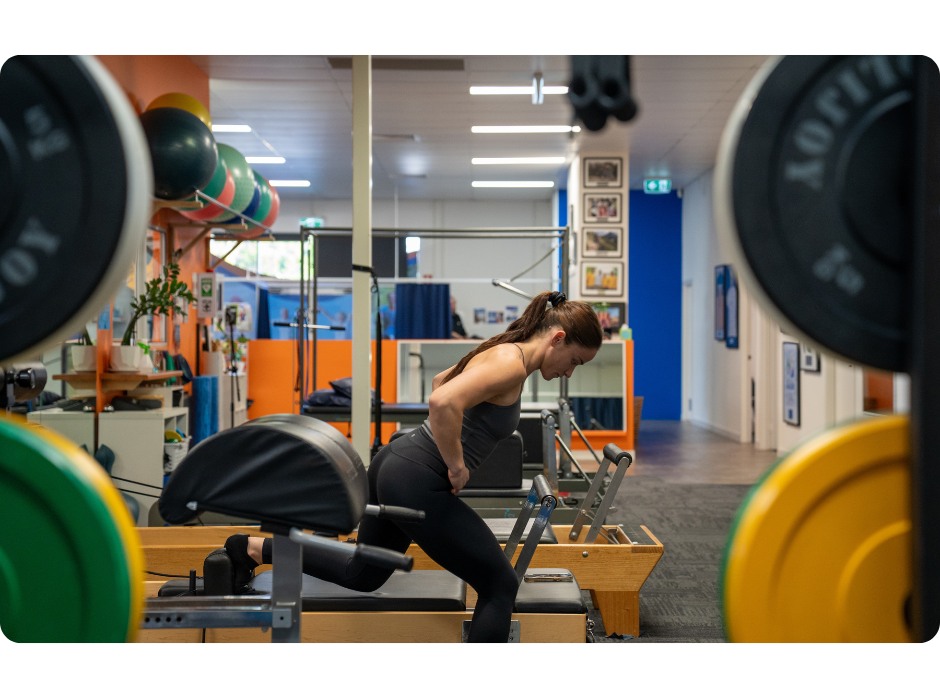 Pilates Exercise Gold Coast Physio Athlete using Pilates Reformer